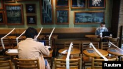 Tables and chairs are taped up to aid social distancing at a Starbucks coffee shop on April 2, 2020, following the COVID-19 outbreak in Hong Kong. 