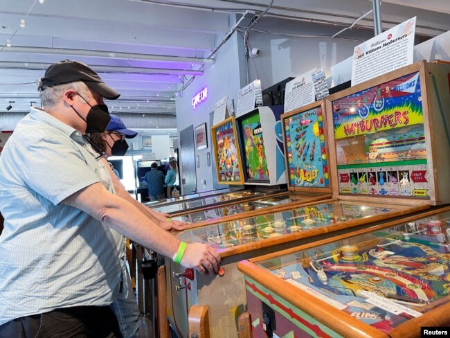 Guests visit Silverball Retro Arcade, which is home to more than 150 fully functional pinball machines in Asbury Park, New Jersey, U.S., August 12, 2022. (REUTERS/Roselle Chen))))