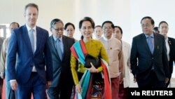 FILE - Myanmar State Counsellor Aung San Suu Kyi departs from Naypyidaw International Airport ahead of her appearance at the International Court of Justice, Dec. 8, 2019, to defend the nation against charges of genocide of its Rohingya Muslim minority.