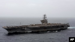 FILE - In this Sept. 7, 2020, file photo released by the US Navy, the aircraft carrier USS Nimitz transits the Arabian Sea.