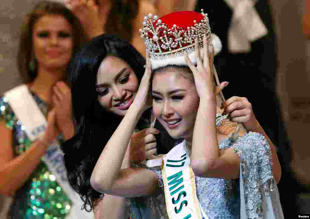 The winner of the Miss International 2017 pageant, Kevin Lilliana (R), representing Indonesia, receives her crown from Miss International 2016 pageant winner Kylie Verzosa, representing Philippines, at the 57th Miss International Beauty Pageant in Tokyo, Japan.
