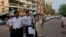 A Burma census enumerator and volunteers walk in a Muslim neighborhood collecting information in Rangoon, March 30, 2014. 