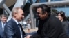 Russia -- Russian President Vladimir Putin (L) talks to U.S. actor Steven Seagal (R), while visiting the oceanarium on Russkiy island outside Vladivostok, Primorsky Krai, September 4, 2015