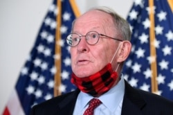 FILE - Senator Lamar Alexander speaks to reporters before a luncheon on Capitol Hill in Washington, July 23, 2020.