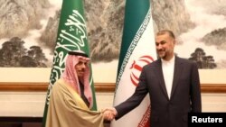 FILE- Iranian Foreign Minister Hossein Amirabdollahian, right, meets with Saudi Arabia's Foreign Minister Prince Faisal bin Farhan Al Saud in Beijing.