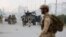 Afghan security forces gather at the site of a complex attack by Taliban fighters in front of the Parliament, in Kabul, Afghanistan, June 22, 2015. 