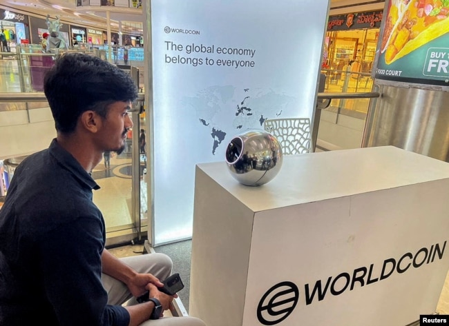 FILE - Kaleem, 22, an engineer in Bengaluru, signs up for WorldCoin by having his eyes scanned by the spherical device in Mantri Square Mall in Bengaluru, India July 25, 2023. (REUTERS/Medha Singh)