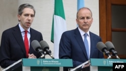PM Irlandia Simon Harris (kiri), didampingi Menlu Irlandia Michel Martin menyampaikan pidato saat konferensi pers, untuk mengakui negara Palestina di gedung Pemerintah di ibu kota Dublin (foto: dok). 