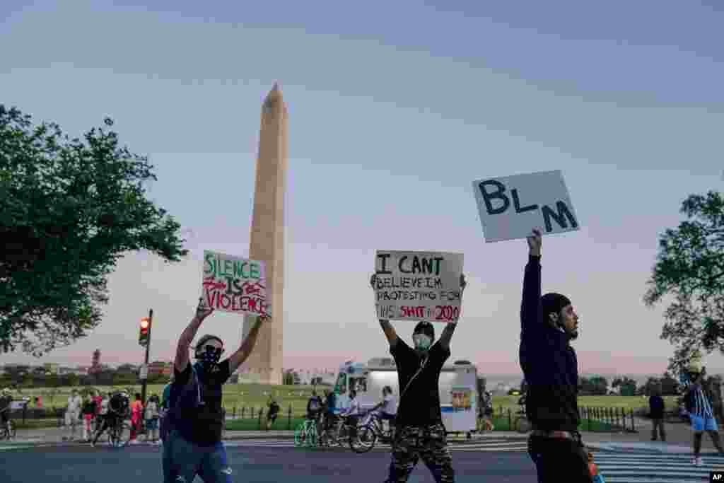 Demonstrators march past the Washington Monument at they protest the death of George Floyd, May 31, 2020.