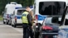 German police officers check the documents of a driver of a car with French license plates near the border with Belgium, in Aachen, Germany, Sept. 16, 2024, as Germany begins expanding checks at all of its land borders.