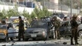 NATO and Afghan security forces inspect the site of a suicide attack in Kabul, Sept. 16, 2014.