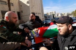 Mourners carry the body of a member of the Fatah movement who was killed during an overnight Israeli army raid in the Balata refugee camp in the occupied West Bank ahead of his funeral on Jan. 4, 2025.