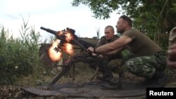 FILE - Members of Ukraine's military fire a grenade launcher in this undated image. That military has asked the United States for 'lethal defensive weapons." A revised GOP proposal calls for "appropriate assistance."