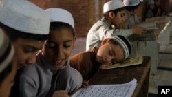 A Pakistani religious student takes a nap in a class during the Islamic month of Ramadan, in Peshawar, Pakistan, June 17, 2016.