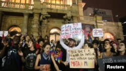 Demonstrators shout slogans against Jair Bolsonaro, far-right lawmaker and presidential candidate of the Social Liberal Party, during a protest march in Sao Paulo, Brazil Oct. 11, 2018. 