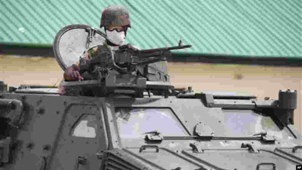 A soldier sits atop an armored personnel carrier in Maiduguri, Nigeria.