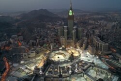 FILE - An aerial view of Saudi Arabia's holy city of Mecca, with the Abraj al-Bait Mecca Royal Clock Tower overlooking the Grand Mosque and Kaaba in the center, is seen during the early hours of Eid al-Fitr.