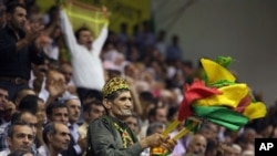 The supporters of the pro-Kurdish Peace and Democracy Party wave their flags during the party's congress in Ankara, Turkey, Sunday, Sept. 4, 2011.