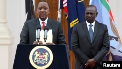 FILE - Kenyan President Uhuru Kenyatta, left, with Deputy President William Ruto, addresses a news conference at the State House in Nairobi, Dec. 2, 2014. 