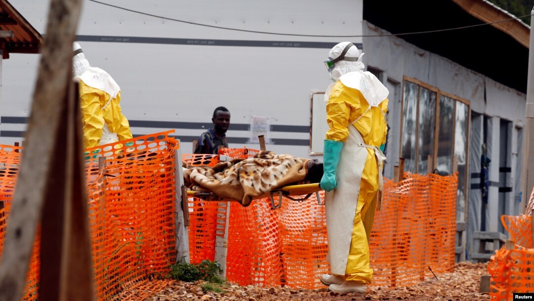FILE - Health workers carry a newly admitted confirmed Ebola patient into a treatment centre in Butembo in the eastern Democratic Republic of Congo, March 28, 2019.