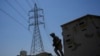 FILE - Members of the Iraqi army secure main power lines between regional towers in Baghdad, Iraq, Aug. 8, 2023.