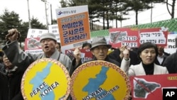 South Korean protesters rally against the annual joint military exercises between South Korea and the United States in front of the South Korean and United States War Command Center in Seongnam, South Korea, Feb. 28, 2011.