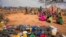 FILE - People wait for food and water in the Warder district in the Somali region of Ethiopia, Jan. 28, 2017.
