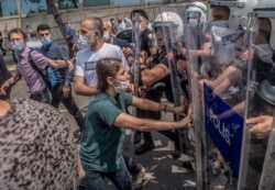 Demonstrators clash with Turkish riot police in Istanbul, during a "March for Democracy" called by Republican People's Party (HDP), after three opposition MPs were revoked and sent to prison at Silivri, June 15, 2020.