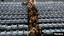 FILE - Participants of a jirga leave an assemply space in Kabul, Afghanistan, Nov. 24, 2013.