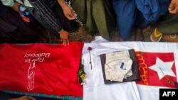 This photo taken May 10, 2021, and received courtesy of an anonymous source via Facebook on May 19, 2021, shows mourners standing around the coffin of poet Khet Thi during his funeral in Pearl town, Myanmar.