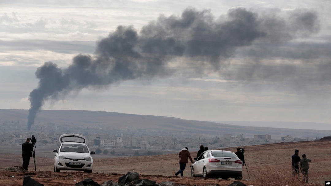 Asap membumbung setelah serangan udara di Kobani, Suriah, dalam pertempuran antara Kurdi dan militan Negara Islam atau ISIS, 19 Oktober 2014.