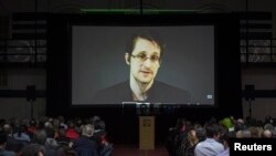 FILE - Former U.S. National Security Agency contractor Edward Snowden appears live via video during a student-organized world affairs conference at the Upper Canada College private high school in Toronto, Feb. 2, 2015. 