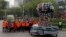 Rescue workers and volunteers that participated in rescue operations after the Sept. 19 earthquake, march behind a fist made out of safety helmets, as they lead the Day of the Dead parade on Mexico City's main Reforma Avenue, Oct. 28, 2017. 