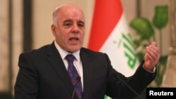 Iraq's Prime Minister-designate Haider al-Abadi gestures during a news conference in Baghdad, Iraq, Aug. 25, 2014.