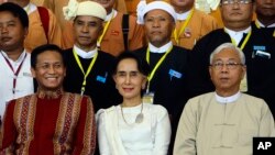 Myanmar's Foreign Minister Aung San Suu Kyi, center, sits with Myanmar's President Htin Kyaw, (Right), and Vice President Henry Van Hti Yu as they smile for a photo session following the Union Peace Conference-21st Century Panglong.