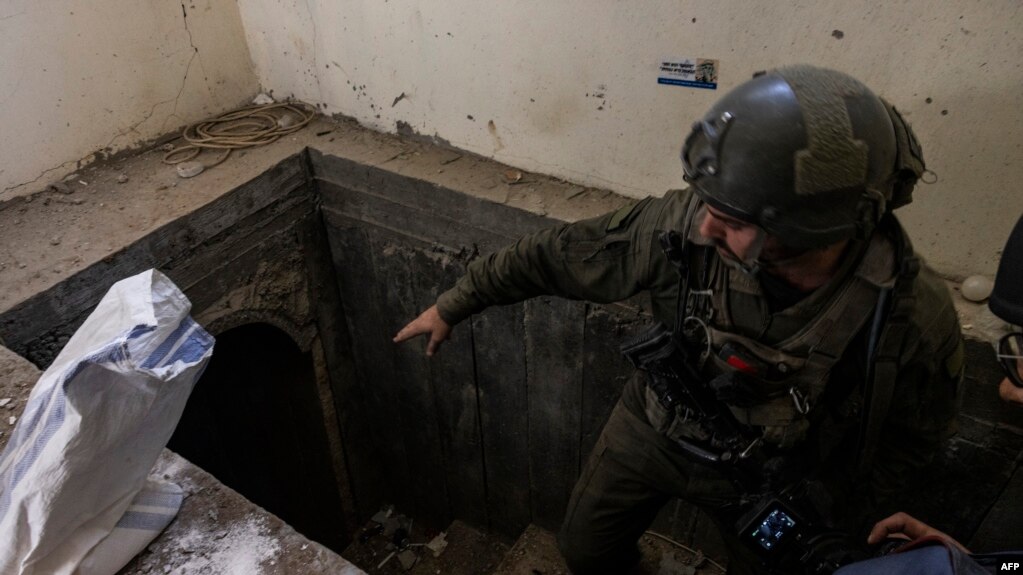 FILE - This picture taken during a media tour organised by the Israeli military on January 8, 2024, shows a soldier standing at the entrance of a tunnel in al-Bureij in the central Gaza Strip.