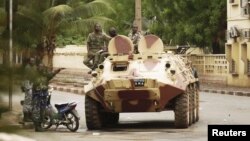 Malian military junta troops who carried out a coup in March guard a street after renewed fighting in the capital Bamako, May 1, 2012