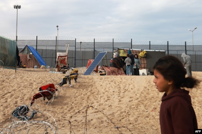 Displaced Palestinians camp near the border fence between Gaza and Egypt, Feb. 16, 2024, in Rafah, in the southern Gaza Strip, amid the ongoing conflict between Israel and the Palestinian Hamas militant group.