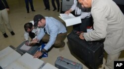 Samples brought back by the U.N. chemical weapons inspection team are checked in upon their arrival at The Hague, Netherlands, August 31, 2013.