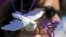 FILE - Jennifer Gordon holds a fabric dove at the base of balloons as she pays tribute to musician Prince at a makeshift memorial outside the fence of Paisley Park, his home and recording studio, in suburban Minneapolis, Minnesota, April 22, 2016.