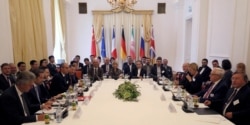 Participants are seen at a meeting held as part of closed-door nuclear talks with Iran, at a hotel in Vienna, Austria, Sunday, July 28, 2019.