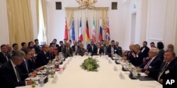 Participants are seen at a meeting held as part of closed-door nuclear talks with Iran, at a hotel in Vienna, Austria, Sunday, July 28, 2019.