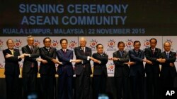 ASEAN leaders from left, Philippine President Benigno Aquino III, Singapore's Prime Minister Lee Hsien Loong, Thai Prime Minister Prayuth Chan-ocha, Vietnam's Prime Minister Nguyen Tan Dung, Malaysia's Prime Minister Najib Razak, Laos' Prime Minister Thongsing Thammavong, Brunei's Sultan Hassanal Bolkiah, Cambodia's Prime Minister Hun Sen, Indonesia's Prime Minister Joko Widodo and Myanmar's President Thein Sein join their hands as they pose for photographers after the signing ceremony of the 2015 Kuala Lumpur Declaration on the Establishment of the Association of Southeast Asian Nations (ASEAN) Community and the Kuala Lumpur Declaration on ASEAN 2025, in Kuala Lumpur, Malaysia, Sunday, Nov. 22, 2015. (AP Photo/Lai Seng Sin)