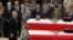 Lebanon's President Michel Suleiman pays his respects after placing honorary medals at the coffins of slain intelligence officer Wissam al-Hassan and his bodyguard Ahmed Sahyouni during an official ceremony to pay tribute their deaths, at the Internal Sec
