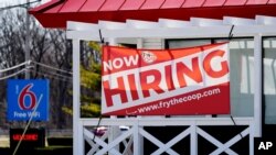 A hiring sign shows outside of restaurant in Prospect Heights, Illinois, March 21, 2021.