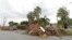 Piles of debris are shown on the sidewalks in front of homes waiting to be hauled away, Sept. 27, 2017, in Hialeah, Fla. Up and down Florida's peninsula, county officials say tree limbs made up the bulk of the storm debris.