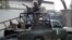Pakistani security forces stand guard at the site of a deadly blast by four Taliban suicide bombers in Bannu, Pakistan, December 10, 2012.