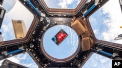 FILE - A mosaic by French artist Invader floats in the International Space Station in 2015. (Samantha Cristoforetti/ESA-NASA via AP)