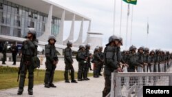 FILE - Army officers stand guard outside the Planalto Palace, in Brasilia, Brazil Jan. 11, 2023. 