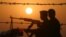 Iraqi soldiers conduct a patrol at sunset near the border with Kuwait in this file photo.